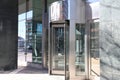 A large stainless steal and glass revolving door in front of an office building in downtown Atlanta
