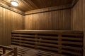 Large standard design classic wooden russian bath sauna interior with hot stones Royalty Free Stock Photo