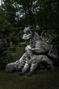 Large statue of the Dragon bitten by a lion and a dog at the famous Parco Dei Mostri in Italy