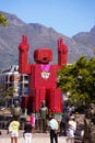 Large statue of a man made of red soft drink crates