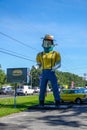 Large statue of young farmer wearing a face mask in front of Mr. Bills restaurant