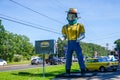 Large statue of young farmer wearing a face mask in front of Mr. Bills restaurant