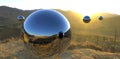 Large steel balls with a reflective surface fly through the air over a mountain village at dawn. The purpose is unknown. Probably