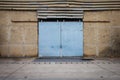 Large steel doors of old warehouses are closed.