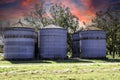 Large steel industrial pecan silos containers on a farm in the country Royalty Free Stock Photo