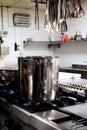 Large steel professional pan on the stove with fire in the restaurant kitchen Royalty Free Stock Photo