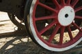 Large steel wheels of old steam locomotive red with white outline