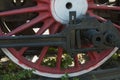 Large steel wheels of old steam locomotive red with white outline