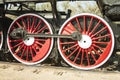 Large steel wheels of old steam locomotive red with white outline