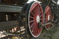 Large steel wheels of old steam locomotive red with white outline