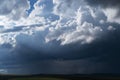 A large steppe with dried tall grass at the foot of a mountain range under thunderclouds in early autumn. Kurai steppe Royalty Free Stock Photo