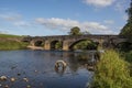 Large stone bridge crossing the river ribble near Clitheroe. Edisford bridge with rocks in the foreground Royalty Free Stock Photo