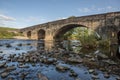 Large stone bridge crossing the river ribble near Clitheroe. Edisford bridge with rocks in the foreground Royalty Free Stock Photo