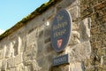 Large, stone-built Sign depicting the residence of the Bishop of Ely cathedral.