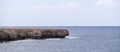 A large stone cape in the sea. Banner with a view of a calm sea, a seascape with a rock