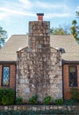 Large Stone Chimney on Small Brick Cottage