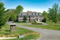 Large, stone, country house with beautiful landscaping