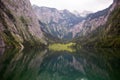 Large stone mountains in the Alps on Obersee Lake with house on shore