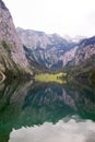 Large stone mountains in the Alps on Obersee Lake with house on shore