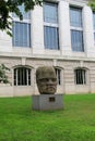 Large stone Olmec colossal head on pedestal in front of Natural History Museum, Washington, DC, 2017