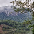 A large stone wall towers over the lake