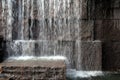 Large stone wall with water splashing from above Royalty Free Stock Photo