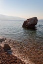 stone in the water at the shore of the sea, on a summer day on the beach in Croatia Royalty Free Stock Photo