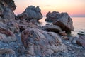 Large stones with beautiful texture on the background of dawn on the sea Royalty Free Stock Photo