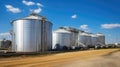 Large storage tanks and silos used for storing raw materials in an industrial facility Royalty Free Stock Photo