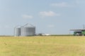 Large storage tower silo in farmyard of Texas farm ranch house prairie Royalty Free Stock Photo