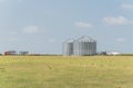 Large storage tower silo in farmyard of Texas farm ranch house prairie Royalty Free Stock Photo