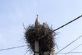 Large stork nest on an electric concrete pole