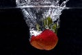 Large strawberry dropped in water Royalty Free Stock Photo