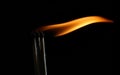 Large striking matches lighter with its flame showing
