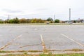 Large suburban parking lot under cloudy sky in autumn