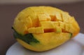 Large sugar tropical mango fruit with no skin ready to eat on white plate look sideways