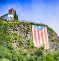 Large sunlit Catalan flag on the rock