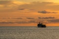 Large supply and support navy ship sail along the sea in the evening before sunset Royalty Free Stock Photo