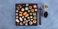 Large sushi set, overhead panoramic shot with sake, soy sauce, and chopsticks Royalty Free Stock Photo