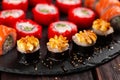 Large sushi set from top on black background close-up. An assortment of various maki nigiri and rolls seafood soy sauce Royalty Free Stock Photo
