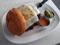 Large Swiss Cheese Hamburger with guacamole, and hot sauce sides