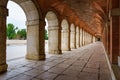 Large symmetrical exterior corridor with arches and columns in the old royal palace of Aranjuez Royalty Free Stock Photo