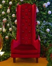 Large tall chair for Santa Claus with Green Christmas Tree in the background