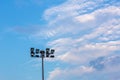 Large tall high outdoor stadium spotlights on rigid frame construction under natural sunlight. Royalty Free Stock Photo