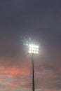 Large tall high outdoor stadium spotlights on rigid frame construction under natural sunlight. Royalty Free Stock Photo