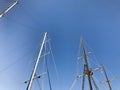 Large tall masts, a vertically standing structure on a ship, a ship supported by braces, guys, a part of sailing equipment on yach Royalty Free Stock Photo