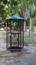 Large and tall outdoor iron bird cage in the middle at the park Royalty Free Stock Photo