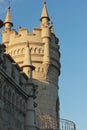 A large tall tower with a clock on the side of a building Royalty Free Stock Photo