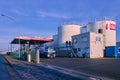 Large tank farm with above ground large tanks and a filling station for tank trucks and ships