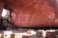 A large tanker cargo ship is being renovated and painted in shipyard dry dock Royalty Free Stock Photo